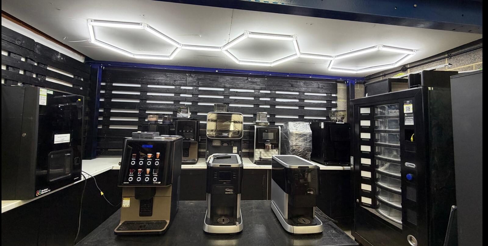 LC Vending Solutions showroom — tabletop bean-to-cup and instant coffee machines lined up for testing and comparison.